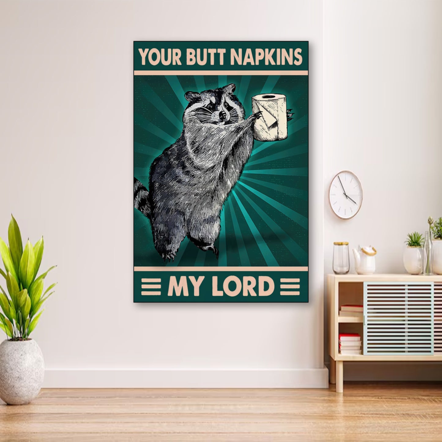 Funny Raccoon Bathroom Poster – “Your Butt Napkins, My Lord” Wall Art wall art displayed in cozy portrait-style interior with minimalist decor